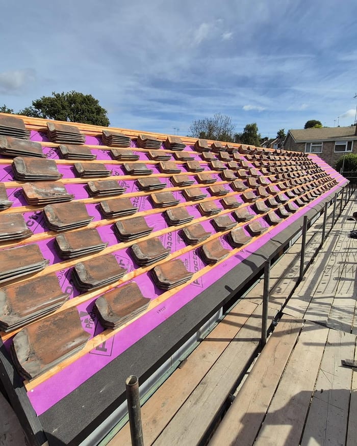 Roof tiles being installed over membrane and battens
