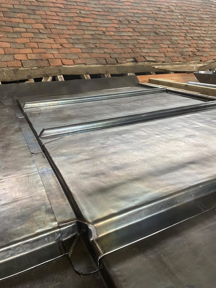Lead flashing beside a brick wall